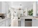 Bright eat-in kitchen with white cabinetry, stainless appliances, and charming dining area at 5915 43Rd E Ct, Bradenton, FL 34203