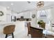 Bright kitchen with white cabinets, stainless appliances, and cozy breakfast nook with wicker chairs at 5915 43Rd E Ct, Bradenton, FL 34203