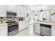 Well-lit kitchen with white cabinetry, stainless steel appliances, and decorative backsplash at 5915 43Rd E Ct, Bradenton, FL 34203