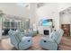 Comfortable living room featuring high ceilings, a fireplace, and seamless access to the screened patio at 5915 43Rd E Ct, Bradenton, FL 34203