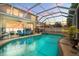 Inviting screened pool area with sun loungers and a built-in hot tub, perfect for relaxation at 5915 43Rd E Ct, Bradenton, FL 34203