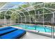 Enclosed pool area featuring a screened-in pool and spa and lounge chairs at 5915 43Rd E Ct, Bradenton, FL 34203
