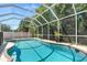 Enclosed pool with attached spa in backyard with screened-in enclosure at 5915 43Rd E Ct, Bradenton, FL 34203
