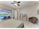 Bedroom featuring a sliding glass door leading to the pool area, complemented by a comfortable armchair at 618 148Th Ne Ct, Bradenton, FL 34212