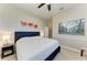 Bedroom featuring a bed with a dark headboard and neutral decor, including contemporary artwork at 618 148Th Ne Ct, Bradenton, FL 34212