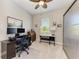 Bright bedroom featuring a ceiling fan, large windows, and a workspace with dual monitors and tasteful decor at 618 148Th Ne Ct, Bradenton, FL 34212