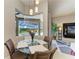 Bright breakfast nook with a glass table, seating for four, and a view of the pool area at 618 148Th Ne Ct, Bradenton, FL 34212