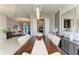 Bright dining room featuring wood table, modern lighting, and views to the living room and pool at 618 148Th Ne Ct, Bradenton, FL 34212