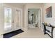 Elegant foyer with decorative glass front doors and an inviting view of the home at 618 148Th Ne Ct, Bradenton, FL 34212
