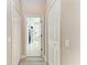 Hallway featuring multiple closets leading to a brightly lit bathroom at 618 148Th Ne Ct, Bradenton, FL 34212