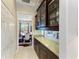 Hallway featuring granite counters, glass-front cabinets, and views into the dining room and living area at 618 148Th Ne Ct, Bradenton, FL 34212