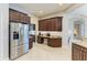Spacious kitchen featuring stainless steel appliances, granite counters, and dark wood cabinetry at 618 148Th Ne Ct, Bradenton, FL 34212
