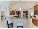 Kitchen featuring a peninsula with bar seating, stainless steel appliances, and dark wood cabinetry at 618 148Th Ne Ct, Bradenton, FL 34212