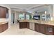Kitchen with granite counters, dark wood cabinets, stainless appliances, and open to the living room at 618 148Th Ne Ct, Bradenton, FL 34212