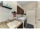 Well-equipped laundry room with modern washer and dryer, ample countertop space, and overhead cabinets at 618 148Th Ne Ct, Bradenton, FL 34212
