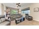 Spacious living room featuring a large window and comfortable seating with plush chairs and a sofa at 618 148Th Ne Ct, Bradenton, FL 34212