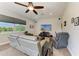 Comfortable living room with a large television, recliner chairs, and neutral carpeting at 618 148Th Ne Ct, Bradenton, FL 34212
