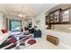 Open-concept living room with patio access, stylish furniture, and a wet bar at 618 148Th Ne Ct, Bradenton, FL 34212