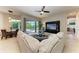 Open-concept living room leading to a dining area and patio with a pool view at 618 148Th Ne Ct, Bradenton, FL 34212
