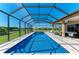 Sparkling in-ground pool surrounded by a screened enclosure and ample deck space at 618 148Th Ne Ct, Bradenton, FL 34212