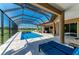 Enclosed pool area featuring comfortable lounge chairs and tiled decking at 618 148Th Ne Ct, Bradenton, FL 34212