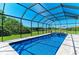 Screened-in pool and spa featuring outdoor seating, and manicured backyard, perfect for enjoying the outdoors at 618 148Th Ne Ct, Bradenton, FL 34212