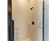 Shower featuring tile surround, shower caddy, and a glass door with a dark bronze trim at 618 148Th Ne Ct, Bradenton, FL 34212