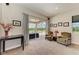 Cozy sitting room with plush chairs, sliding glass doors leading to an outdoor lanai, and decorative accents at 618 148Th Ne Ct, Bradenton, FL 34212
