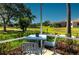 Relax on the back porch with views of lush landscaping, pond, and mature trees at 6442 Tailfeather Way, Bradenton, FL 34203