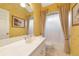 The bathroom features a vanity with an integrated sink, a mirror, and a shower-tub combo at 6442 Tailfeather Way, Bradenton, FL 34203