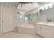 The primary bathroom features an octagonal soaking tub and elegant floral wallpaper at 6442 Tailfeather Way, Bradenton, FL 34203