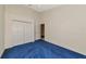 This bedroom features plush blue carpet, a ceiling fan, and a closet for ample storage at 6442 Tailfeather Way, Bradenton, FL 34203