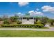 Spacious clubhouse with a light green roof, white pillars, and surrounding greenery at 6442 Tailfeather Way, Bradenton, FL 34203