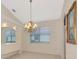 Bright dining room with tray ceilings, decorative chandelier, tile floors and large windows for a modern look at 6442 Tailfeather Way, Bradenton, FL 34203