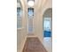 Bright foyer with arched doorway, tile floors, and decorative rug adds elegance to this inviting home at 6442 Tailfeather Way, Bradenton, FL 34203