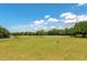 Expansive view of the lush green golf course featuring clear blue skies with scattered clouds at 6442 Tailfeather Way, Bradenton, FL 34203