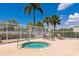 Inviting community hot tub with lounge seating, surrounded by lush landscaping and blue sky at 6442 Tailfeather Way, Bradenton, FL 34203