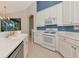 Open kitchen features white cabinetry, modern appliances, and a stylish design for cooking and entertaining at 6442 Tailfeather Way, Bradenton, FL 34203