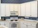 Well-maintained kitchen with white cabinets, laminate countertops, microwave, and gas range at 6442 Tailfeather Way, Bradenton, FL 34203