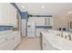 Bright kitchen with stainless steel appliances, tile floors, and ample cabinet space offers modern convenience at 6442 Tailfeather Way, Bradenton, FL 34203