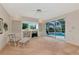 Cozy living room with built-in shelving and a view of the screened in pool area at 6442 Tailfeather Way, Bradenton, FL 34203
