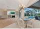 Bright living room with large windows, views of the pool, and comfortable seating, perfect for entertaining at 6442 Tailfeather Way, Bradenton, FL 34203