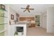 Home office features custom shelving, wood cabinets, built in desk, and a ceiling fan at 6442 Tailfeather Way, Bradenton, FL 34203