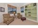 Relaxing sitting area with comfortable chairs, a side table, built in shelving, and natural lighting at 6442 Tailfeather Way, Bradenton, FL 34203