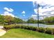 Outdoor tennis courts surrounded by tall fencing, mature trees, and manicured landscaping at 6442 Tailfeather Way, Bradenton, FL 34203