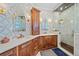 Luxurious bathroom boasting dual sinks, an oversized shower with glass door, and stylish mirrors at 6600 Horned Owl Pl, Sarasota, FL 34241