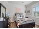 Charming bedroom featuring wall trim, a colorful quilt, and a tv atop the dresser at 6600 Horned Owl Pl, Sarasota, FL 34241