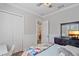 Comfortable bedroom includes double door closet, dresser, and doorway with ensuite bathroom views at 6600 Horned Owl Pl, Sarasota, FL 34241