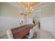 Dining room with white wainscoting, marble floors, and a wooden table at 6600 Horned Owl Pl, Sarasota, FL 34241