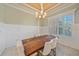 Dining room featuring marble floors, a modern chandelier, and a wooden table at 6600 Horned Owl Pl, Sarasota, FL 34241